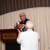 Kevin Corcoran presents a Johnny Manziel, "autographed" football to Texas A&M alum, Biff Johnson. 